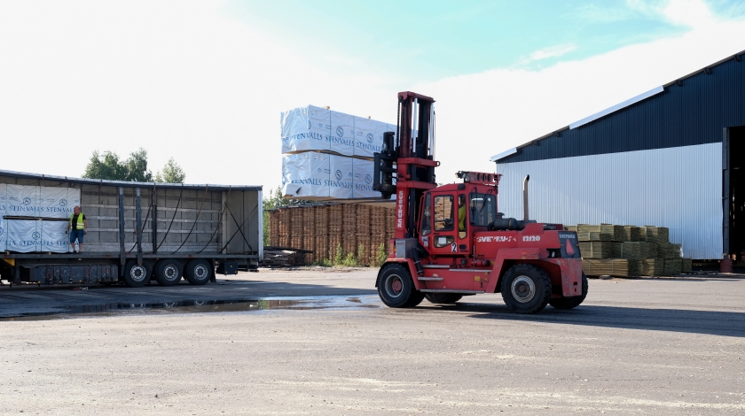 A truck loading lumber packages